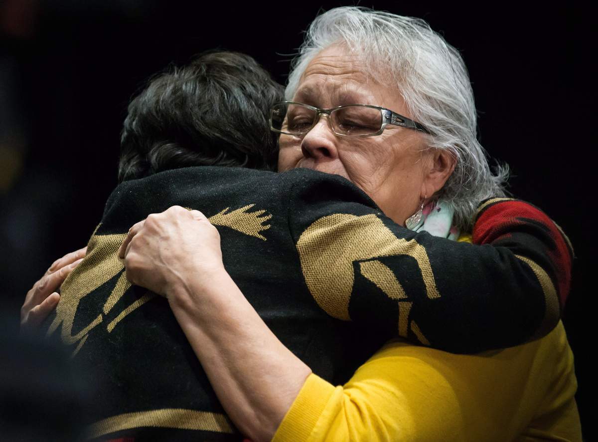 Rita Blind, right, sheds tears while embracing Viola Thomas after listening to Bernie Williams testify at the final day of hearings at the National Inquiry into Missing and Murdered Indigenous Women and Girls, in Richmond, B.C., on Sunday April 8, 2018.