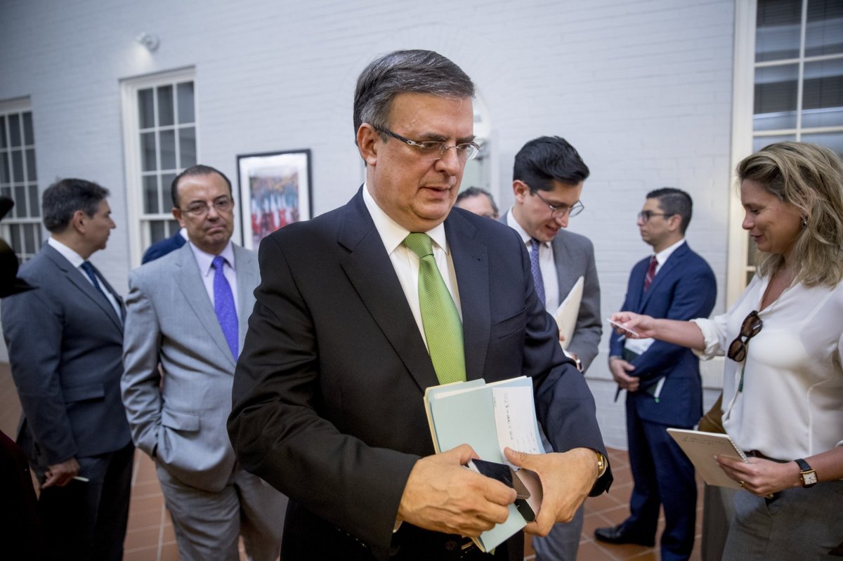 Mexican Foreign Affairs Secretary Marcelo Ebrard, center, departs a news conference at the Mexican Embassy in Washington, Tuesday, June 4, 2019, as part of a Mexican delegation in Washington for talks following trade tariff threats from the Trump Administration. 