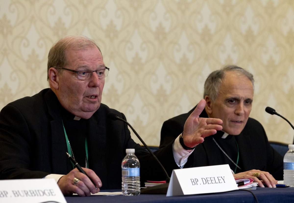 Robert Deeley, left, Bishop of the Diocese of Portland, accompanied by Cardinal Daniel DiNardo, of the Archdiocese of Galveston-Houston and President of the United States Conference of Catholic Bishops (USCCB), speaks during a news conference at the United States Conference of Catholic Bishops (USCCB), 2019 Spring meetings in Baltimore, Md., Tuesday, Jun 11, 2019. 
