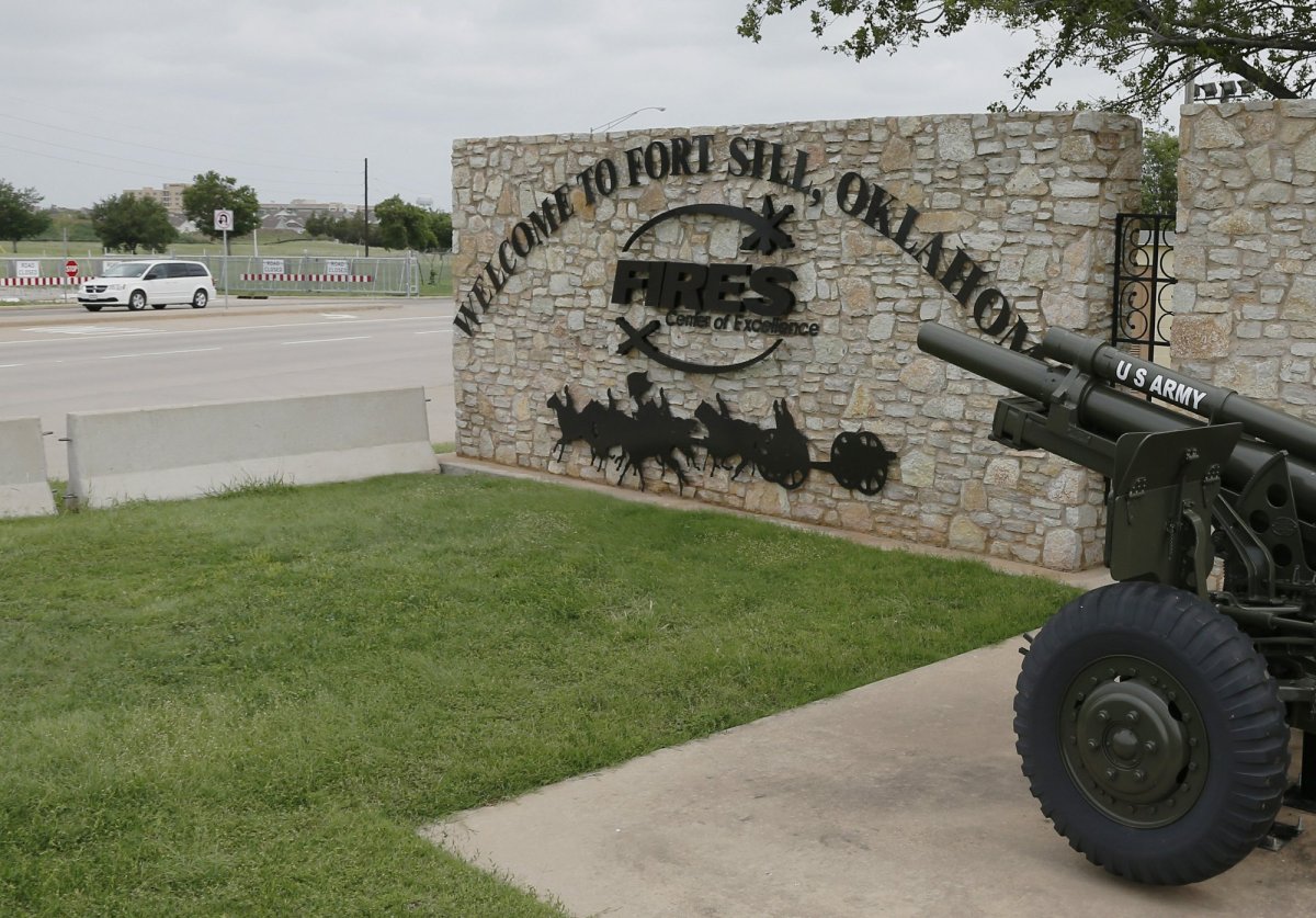 FILE - In this June 17, 2014 file photo, a vehicle drives by a sign at Scott Gate, one of the entrances to Fort Sill, in Fort Sill, Okla. The federal government has chosen Fort Sill, a military base in Oklahoma, as the location for a new temporary shelter to house migrant children. 
