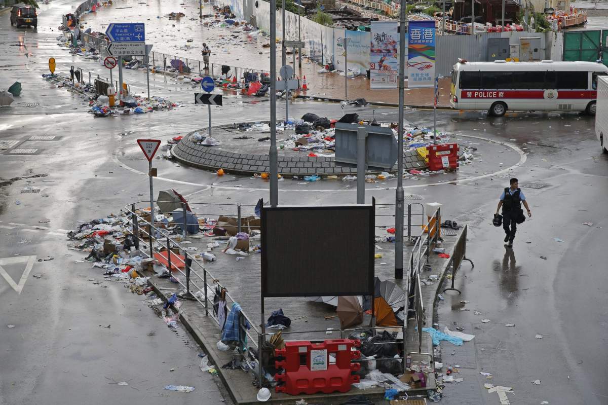 A riot police walks outside the Legislative Council in Hong Kong, Thursday, June 13, 2019. Traffic has been restored in the heart of Hong Kong a day after clashes between police and protesters who oppose legislation that would allow criminal suspects to be sent to mainland China for trial. 
