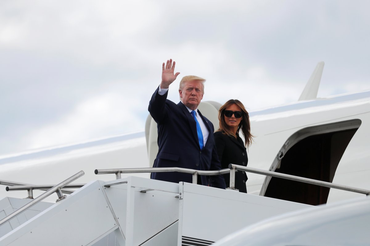 U.S. President Donald Trump, next to first lady Melania Trump, waves as he departs Caen Airport, France, June 6, 2019. 