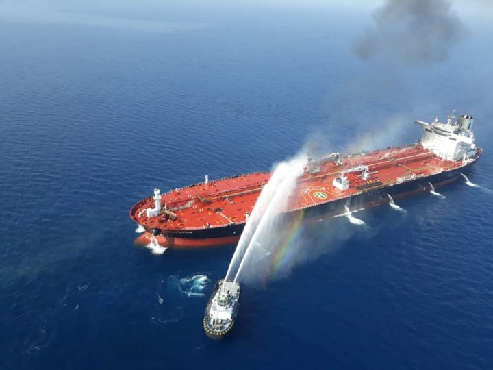 An Iranian navy boat tries to stop the fire of an oil tanker after it was attacked in the Gulf of Oman, June 13, 2019. 