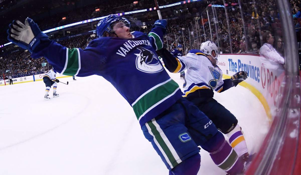 Vancouver Canucks right wing Brock Boeser (6) goes into the boards with St. Louis Blues left wing Alexander Steen (20) during first period NHL action at Rogers Arena in Vancouver, Thursday, Dec. 20, 2018.