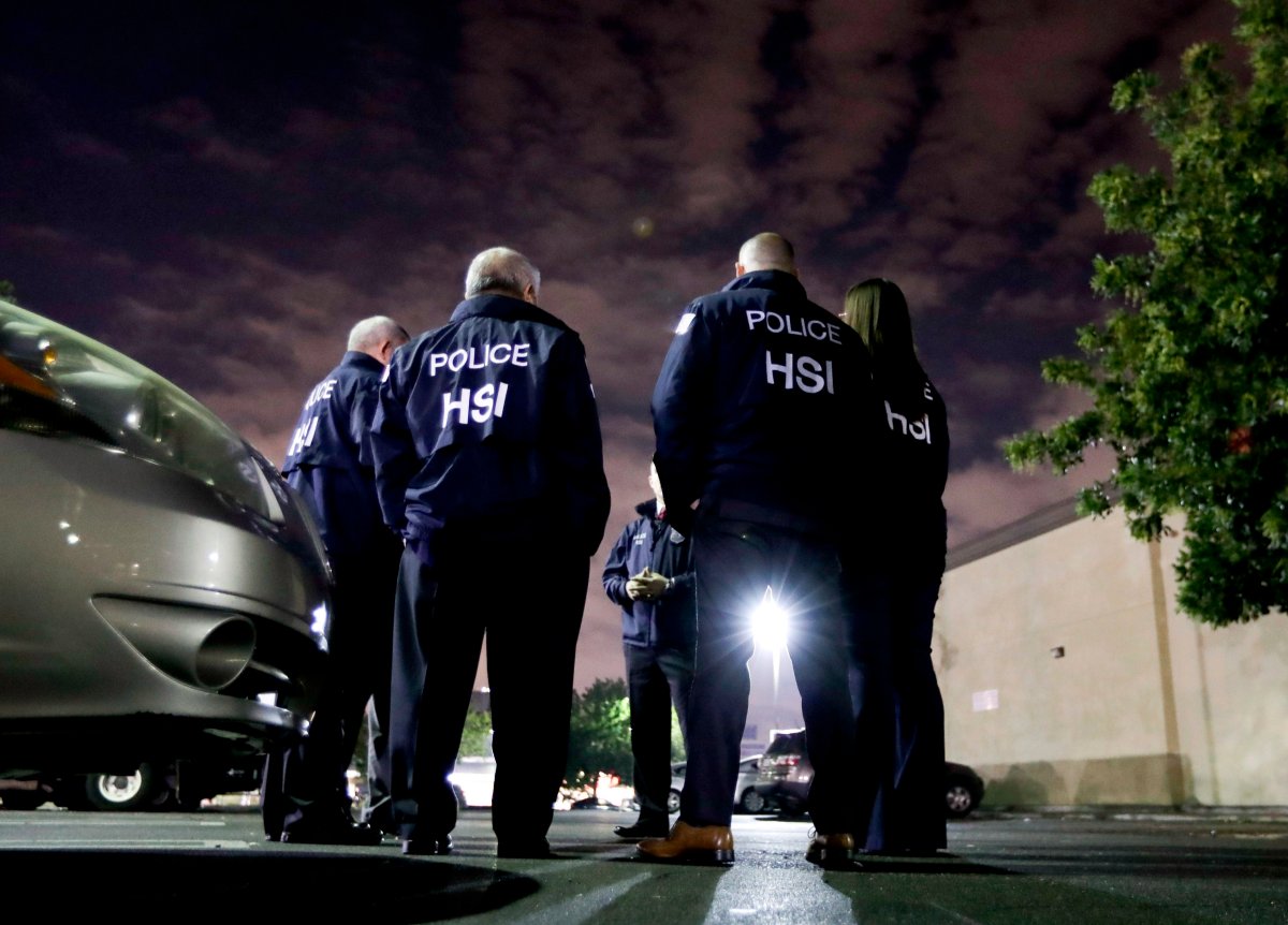 In this Jan. 10, 2018, file photo, U.S. Immigration and Customs Enforcement agents gather before serving an employment audit notice at a 7-Eleven convenience store, in Los Angeles. 