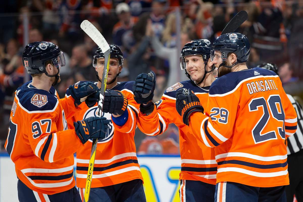 Edmonton Oilers' Connor McDavid (97), Andrej Sekera (2), Matthew Benning (83) and Leon Draisaitl (29) celebrate Benning's goal against the New Jersey Devils during second period NHL action at Rogers Place in Edmonton, Alta., on Wednesday, March 13, 2019. 