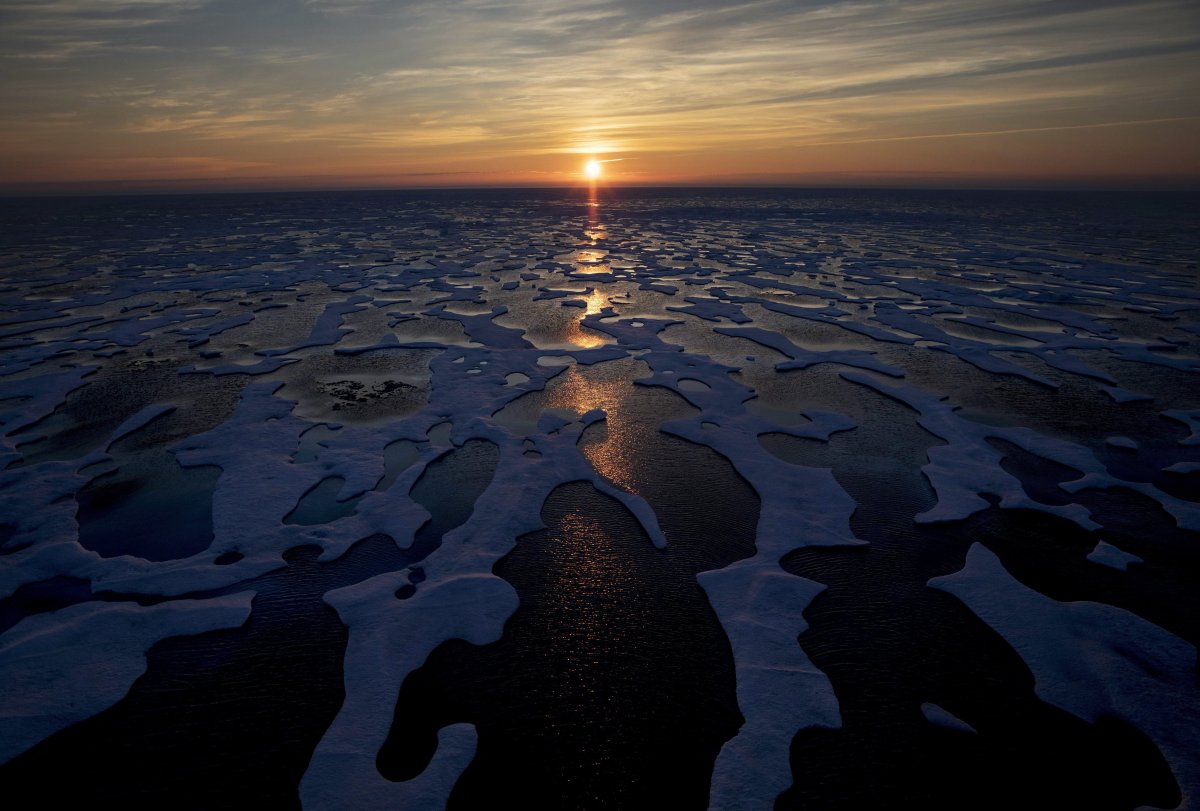 The midnight sun shines across sea ice along the Northwest Passage in the Canadian Arctic Archipelago, on July 22, 2017. Canada is warming up twice as fast as the rest of the world and that warming is "effectively irreversible." .