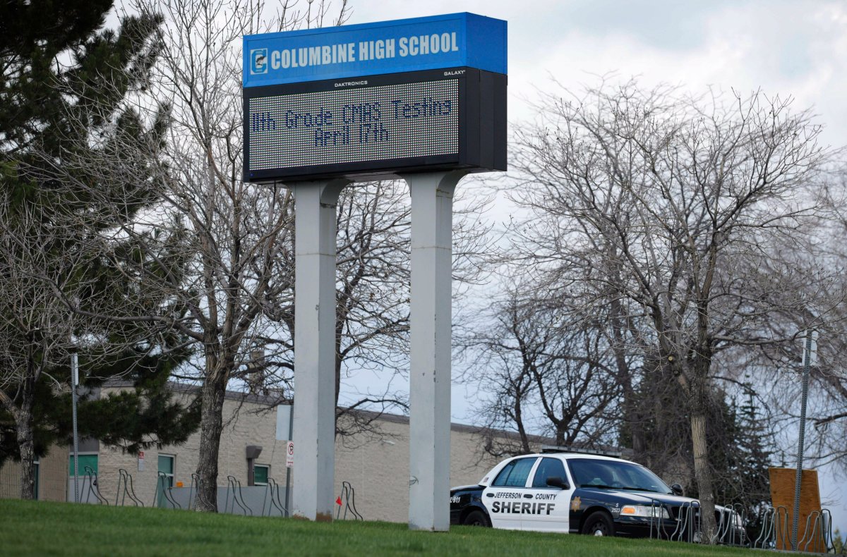 In this April 17, 2019, file photo, a patrol car is parked in front of Columbine High School in Littleton, Colo., where two student killed 12 classmates and a teacher in 1999. 