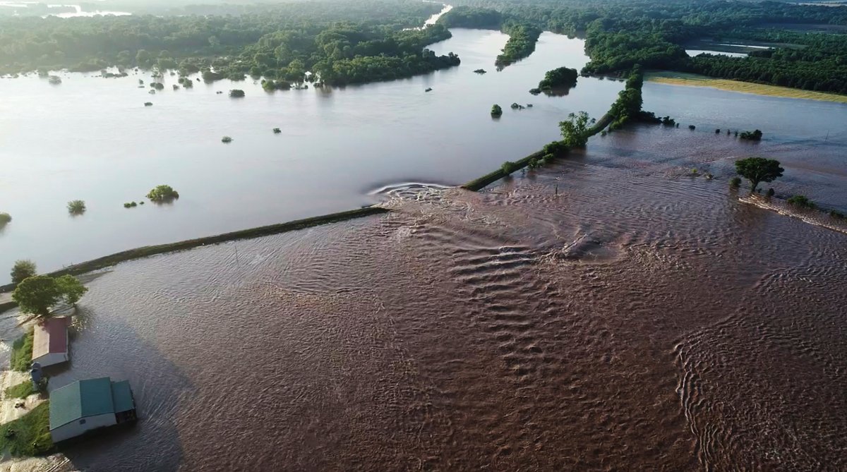 In this aerial image provided by Yell County Sheriff's Department water rushes through the levee along the Arkansas River in Dardanelle, Ark., on Friday, May 31, 2019.