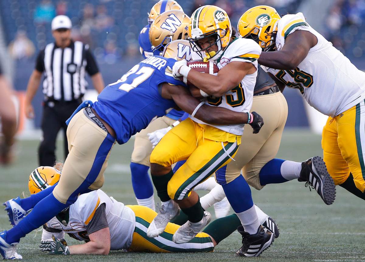 Winnipeg Blue Bombers' Brandon Alexander (37) tackles Edmonton Eskimos' Alex Taylor (33) during the first half of CFL action in Winnipeg Friday, May 31, 2019. THE CANADIAN PRESS/John Woods.