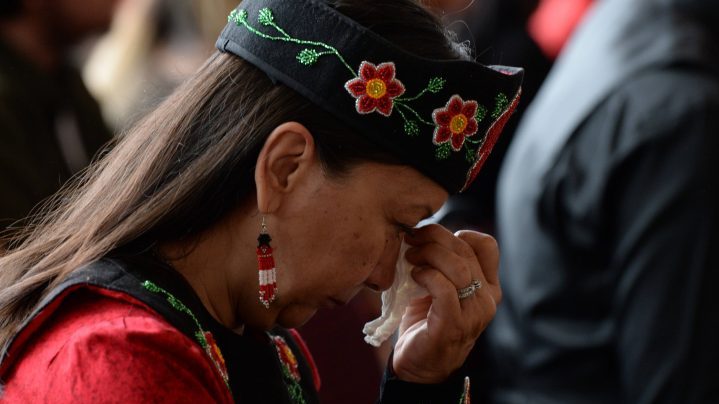 A woman shows her emotions as she listens to speakers during ceremonies marking the release of the Missing and Murdered Indigenous Women report in Gatineau on June 3, 2019.