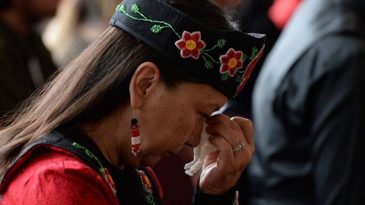 A woman shows her emotions as she listens to speakers during ceremonies marking the release of the Missing and Murdered Indigenous Women report in Gatineau on June 3, 2019.