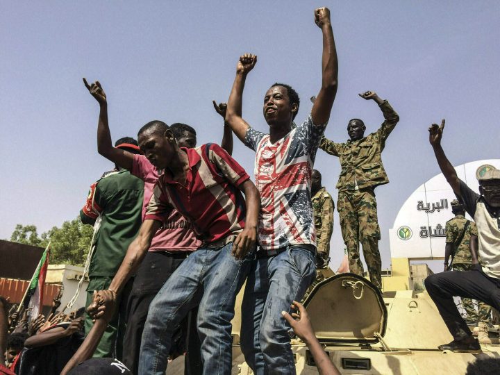 In this April 11, 2019 photo, Sudanese celebrate after officials said the military had forced longtime autocratic President Omar al-Bashir to step down after 30 years in power in Khartoum, Sudan.