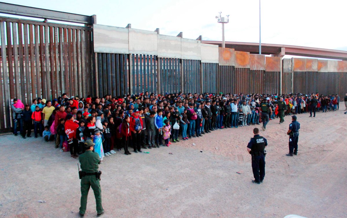 FILE - This May 29, 2019 file photo released by U.S. Customs and Border Protection (CBP) shows some of 1,036 migrants who crossed the U.S.-Mexico border in El Paso, Texas, the largest that the Border Patrol says it has ever encountered.