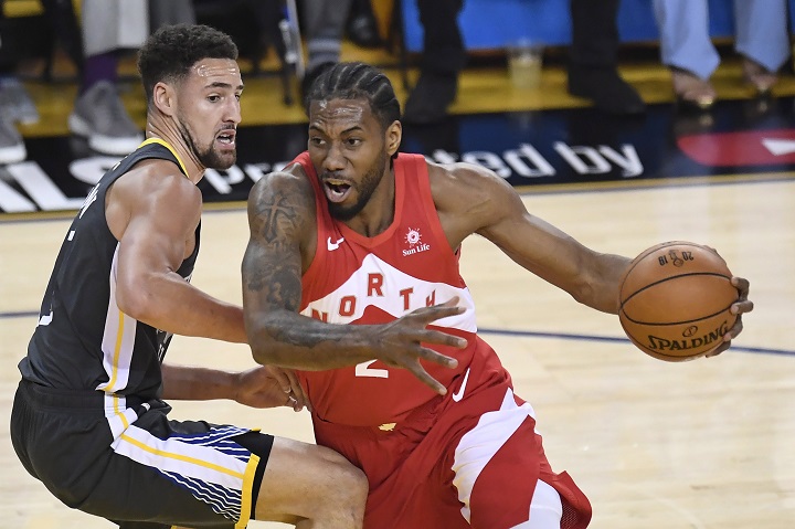 Toronto Raptors forward Kawhi Leonard drives around Golden State Warriors guard Klay Thompson during first-half basketball action in Game 4 of the NBA Finals in Oakland, California on Friday.