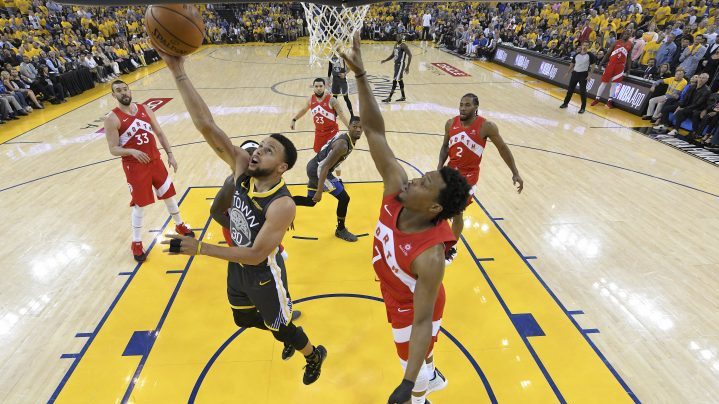 Golden State Warriors guard Stephen Curry, left, shoots in front of Toronto Raptors guard Kyle Lowry during the first half of Game 4 of basketball's NBA Finals in Oakland, Calif., Friday, June 7, 2019.