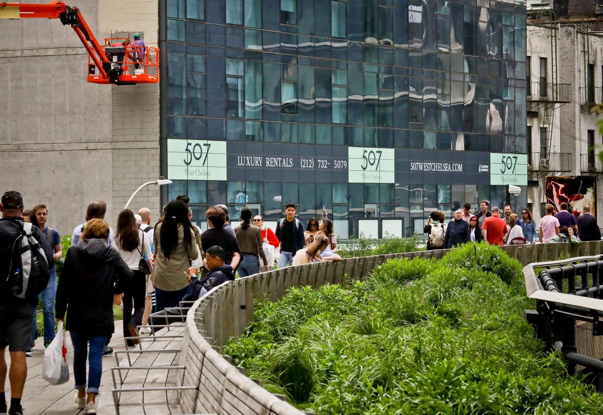 In this May 29, 2019 photo, a new residential hi-rise has new signage installed to advertise its luxury rentals along the High Line park in New York.