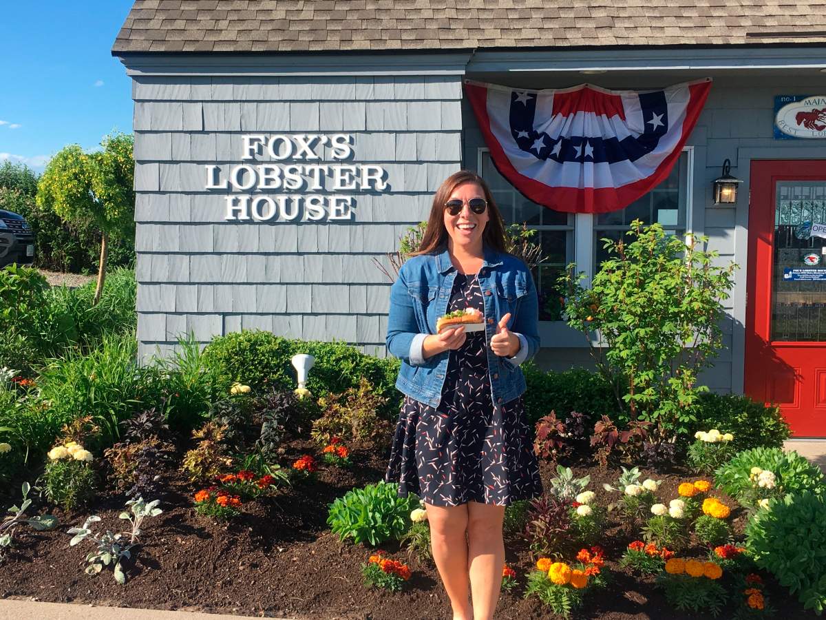 In this Friday, June 7, 2019, photo provided by Alicia Jessop, Jessop poses for a photo with a lobster roll at Fox’s Lobster House in York, Maine.