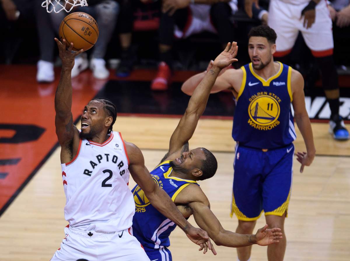 Toronto Raptors forward Kawhi Leonard (2) drive past Golden State Warriors forward Andre Iguodala (9) during first half Game 5 NBA Finals basketball action in Toronto on Monday, June 10, 2019.