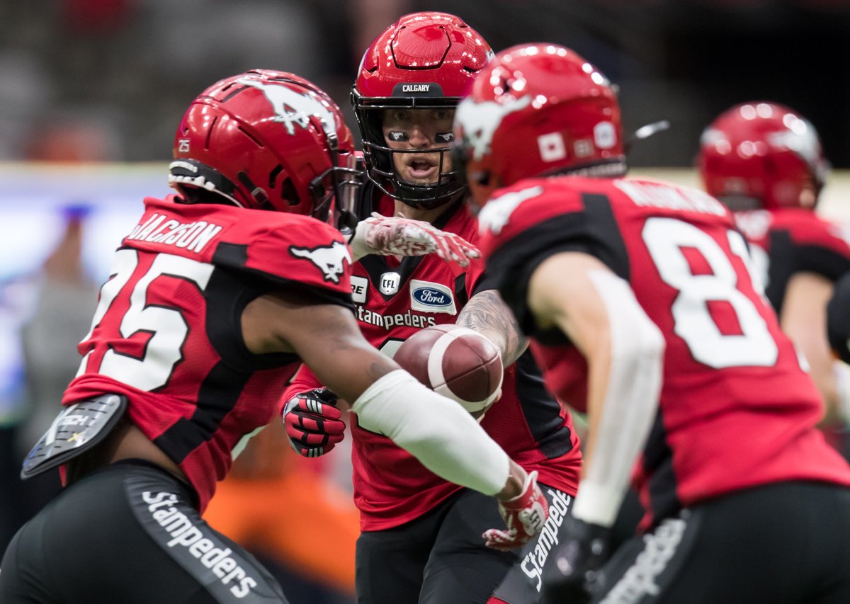 Calgary Stampeders quarterback Bo Levi Mitchell, back, hands off to Don Jackson, front left, during the first half of a pre-season CFL football game against the B.C. Lions in Vancouver on Friday June 7, 2019. Winning last year's Grey Cup after losing to underdog teams two straight years was a pressure valve release for the Calgary Stampeders. 