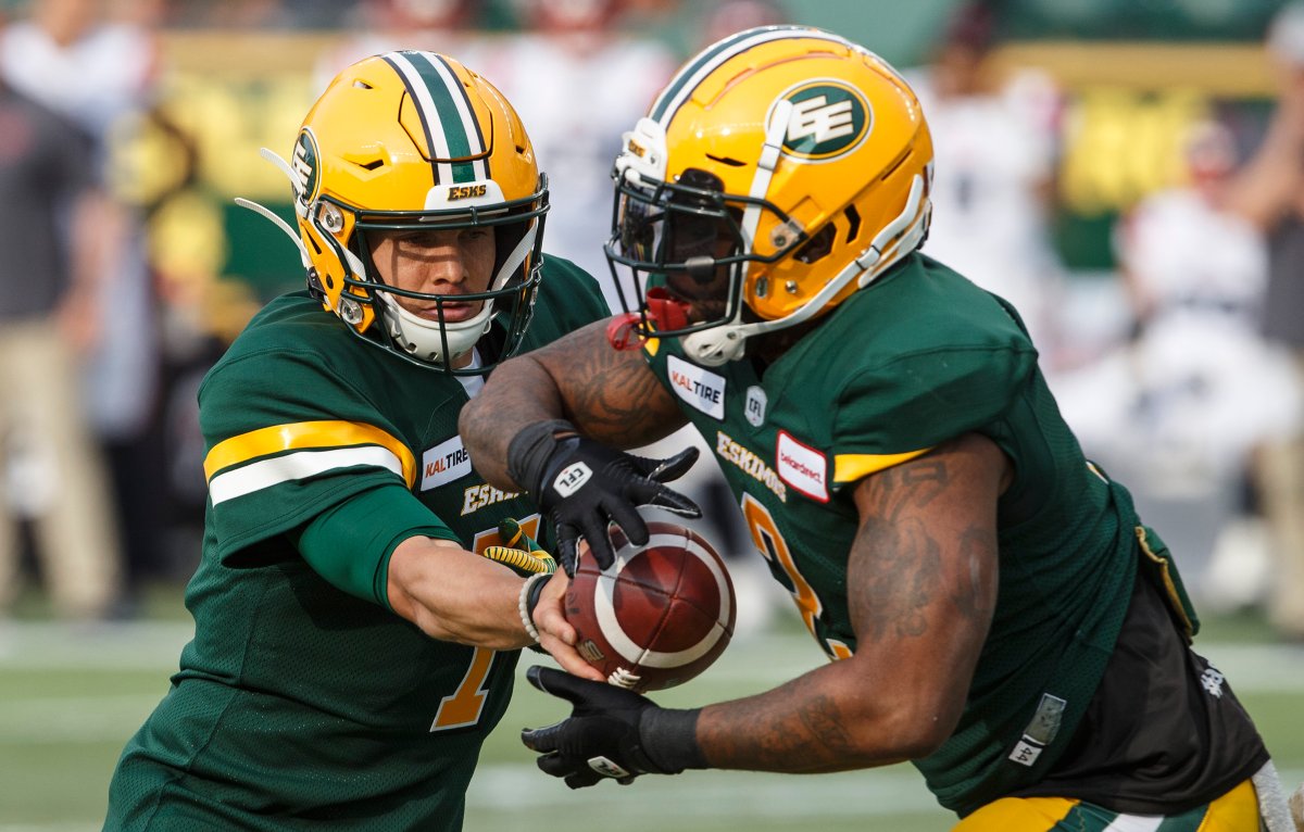 Edmonton Eskimos quarterback Trevor Harris (7) hands the ball off to C.J. Gable (2) against the Montreal Alouettes during first half CFL action in Edmonton on Friday June 14, 2019. 