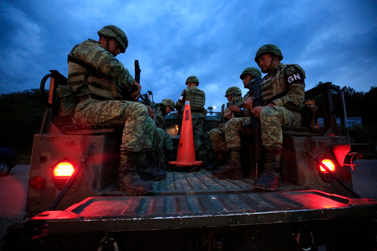 Soldiers forming part of Mexico's National Guard board a truck to patrol back roads used to circumvent a migration checkpoint, in Comitan, Chiapas state, Mexico, Saturday, June 15, 2019.