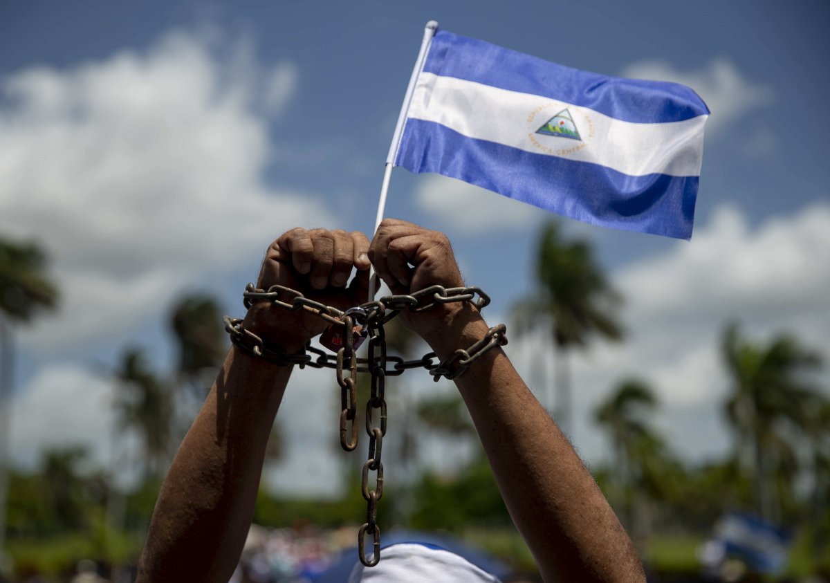 FILE - A man with chains in his hands and a Nicaraguan flag participates in a mass of thanksgiving for the release of what the opposition considers 'political prisoners' at the Metropolitan Cathedral of Managua, in Managua, Nicaragua, 16 June 2019.