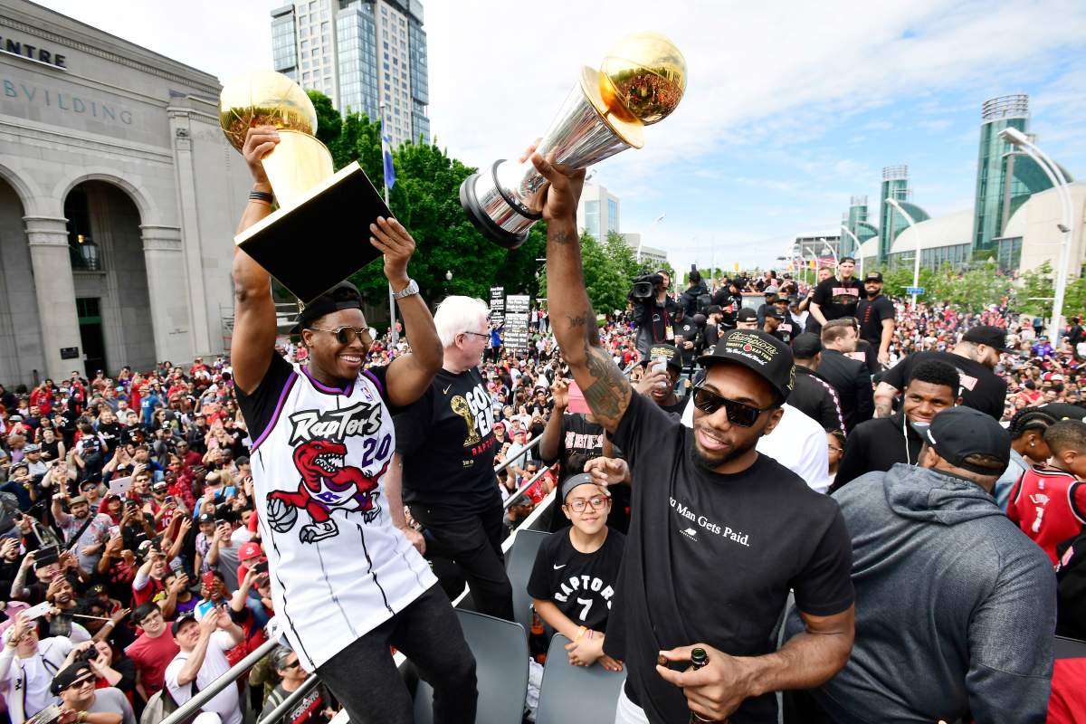 Toronto Raptors guard Kyle Lowry, left, holds the Larry O’Brien Championship Trophy as forward Kawhi Leonard holds his playoffs MVP trophy as they celebrate during the 2019 Toronto Raptors Championship parade in Toronto on Monday, June 17, 2019.