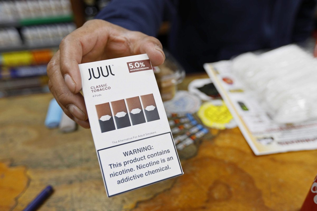 A cashier displays a packet of tobacco-flavoured Juul pods at a store in San Francisco. 