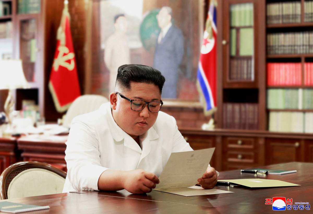 In this undated photo provided on Sunday, June 23, 2019, by the North Korean government, North Korean leader Kim Jong Un reads a letter from U.S. President Donald Trump.