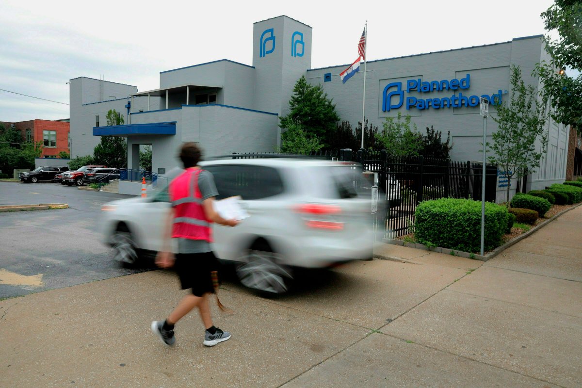 In this June 21, 2019 file photo, an anti-abortion advocate attempts to solicit a motorist entering the parking lot of the Planned Parenthood of the St. Louis Region and Southwest Missouri, the state's last operating abortion clinic in St. Louis.  