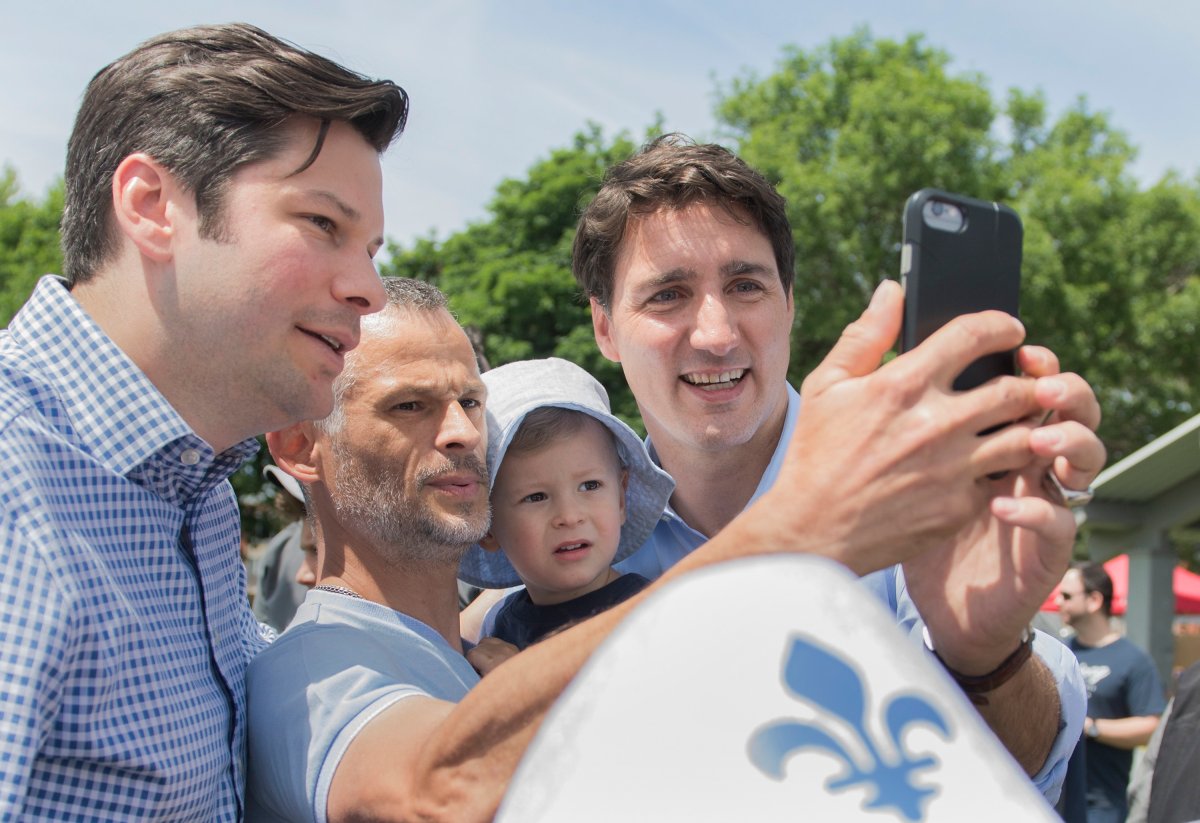 Prime Minister Justin Trudeau, right, poses for a photograph with supporters during Saint-Jean-Baptiste day celebrations in Montreal, Monday, June 24, 2019.