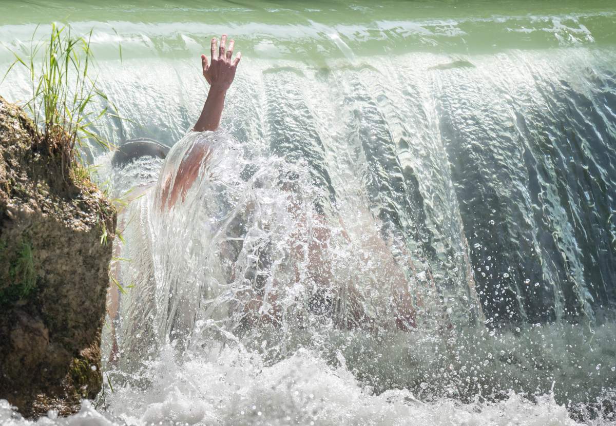 Kids cool down in a stream in the English Garden in Munich, Germany, Tuesday, June 25, 2019. Germany faces a heat wave with temperatures up to 40 degrees Celsius.