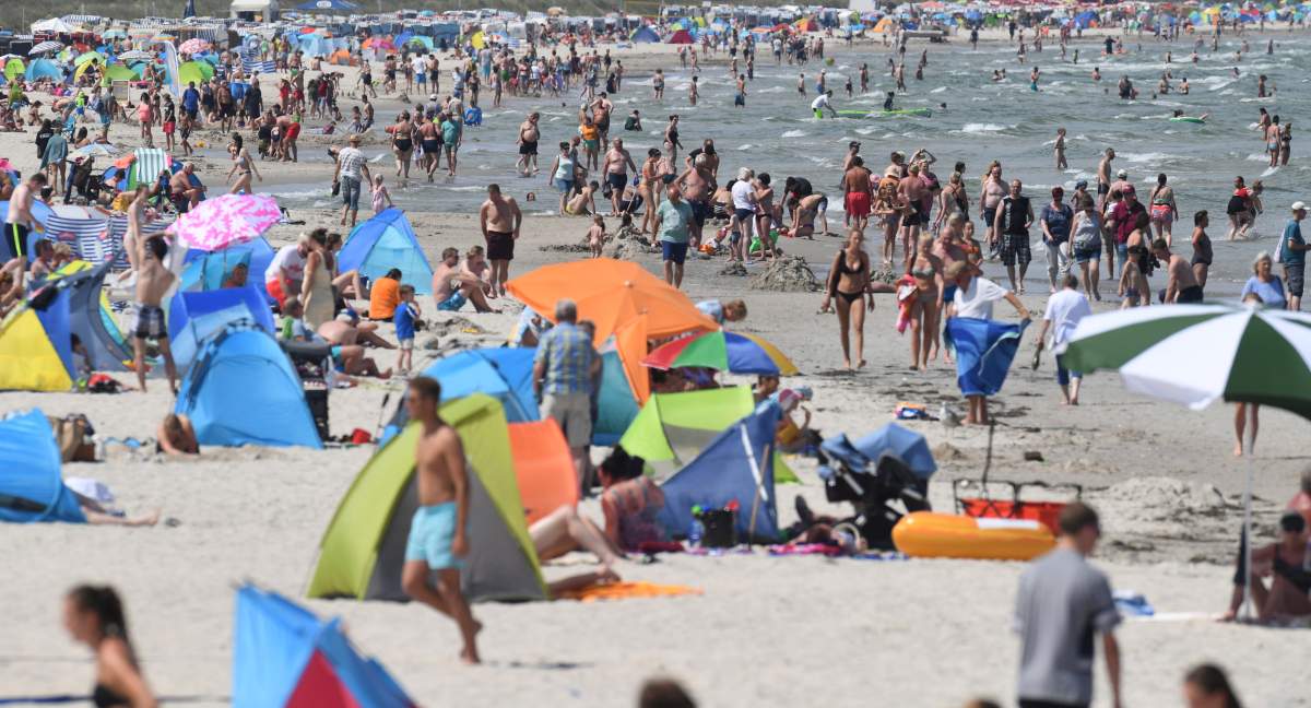 People crowd the beach at the Baltic Sea in Binz, Germany, Tuesday, June 25, 2019. Germany faces a heat wave with temperatures up to 40 degrees Celsius.