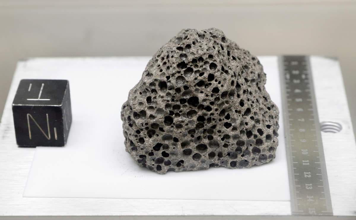 Collected during Apollo 15, a 3.5 billion years old basalt rock similar to rocks formed around Hawaii, is displayed in a pressurized nitrogen-filled examination case inside the lunar lab at the NASA Johnson Space Center Monday, June 17, 2019, in Houston.
