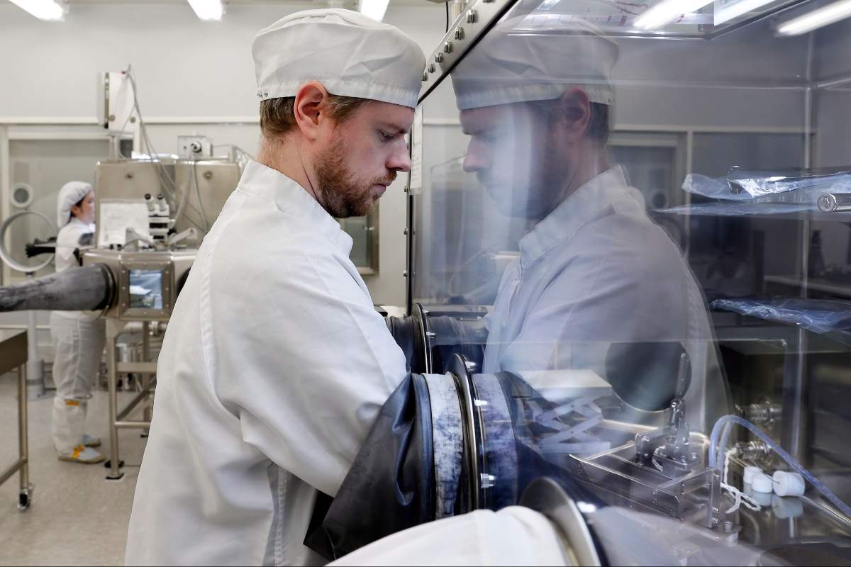 Jeremy Kent, Apollo curation processor, works with lunar samples within a sealed, nitrogen-pressurized examination case inside the lunar lab at the NASA Johnson Space Center Monday, June 17, 2019, in Houston.