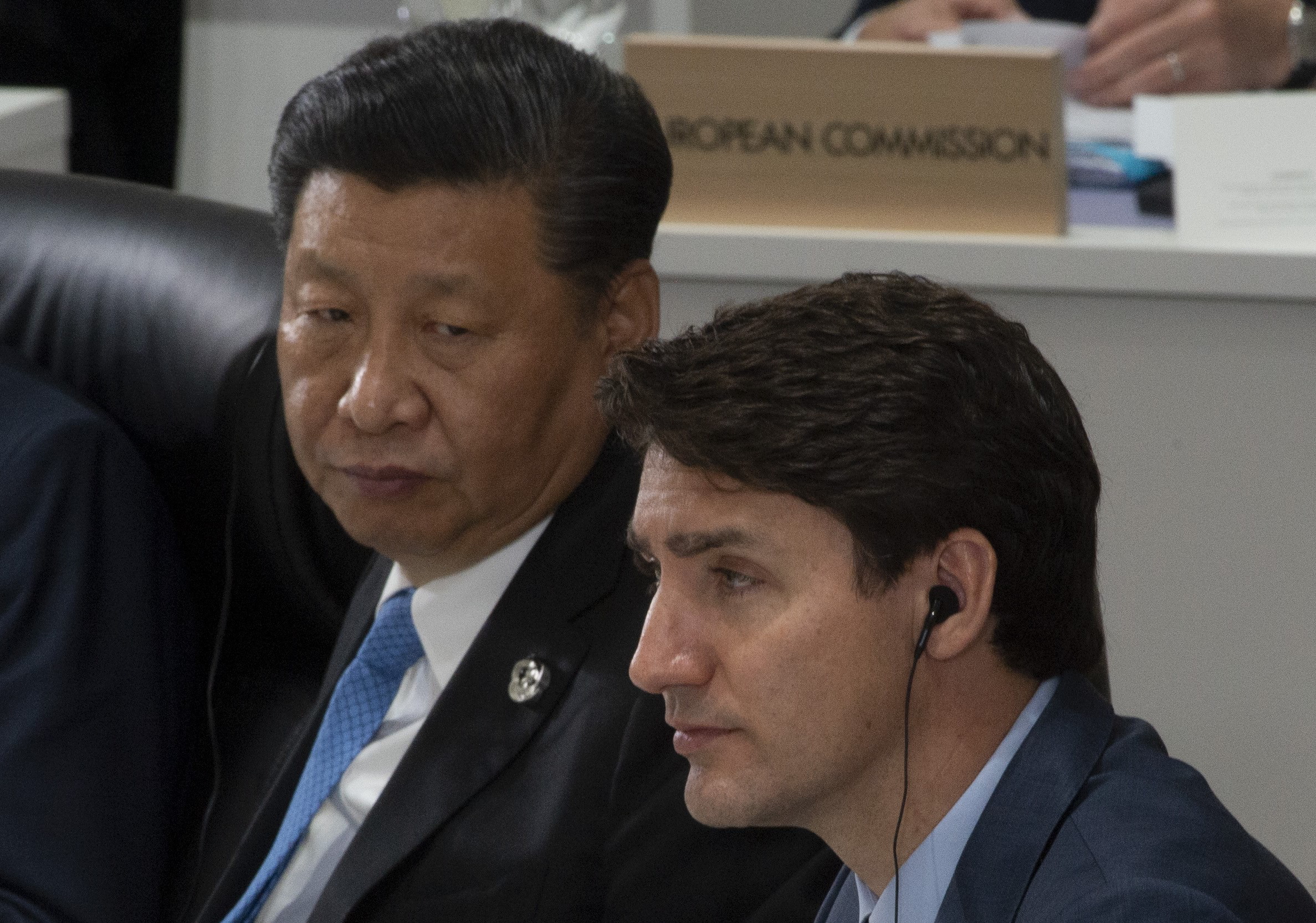 Canadian Prime Minister Justin Trudeau and Chinese President Xi Jinping listen to opening remarks at a plenary session at the G20 Summit in Osaka, Japan, Friday June 28, 2019.
