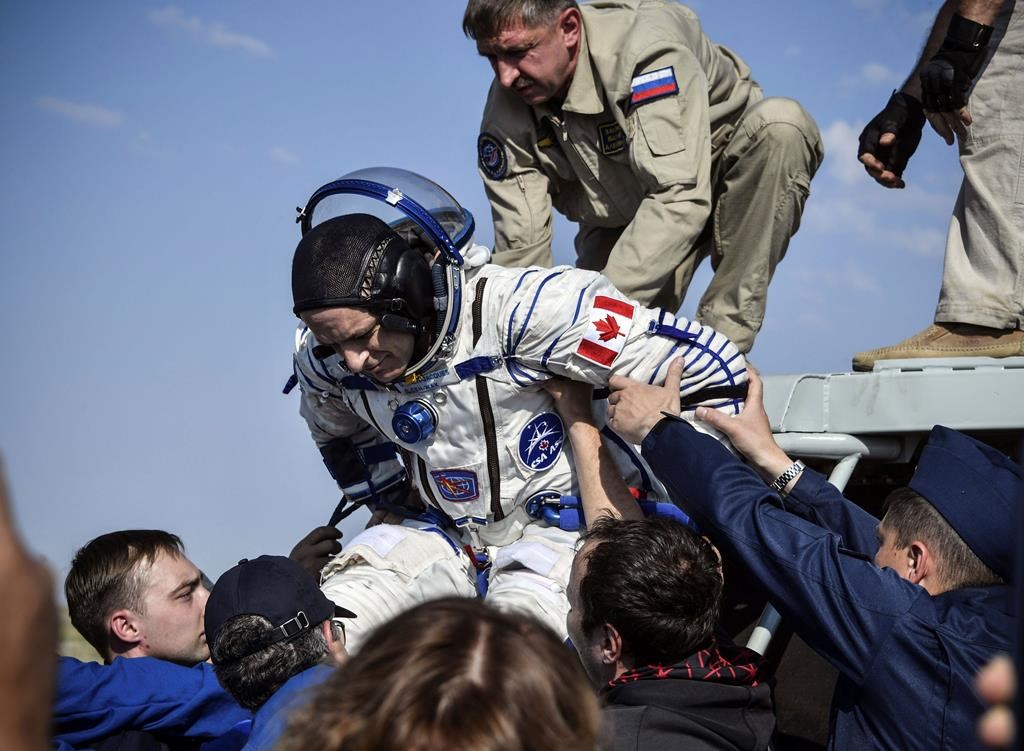 A Russian space agency rescue team helps astronaut David Saint-Jacques get out of the capsule shortly after the landing of the Russian Soyuz MS-11 space capsule about 150 kilometres southeast of the Kazakh town of Zhezkazgan, Kazakhstan, Tuesday, June 25, 2019.