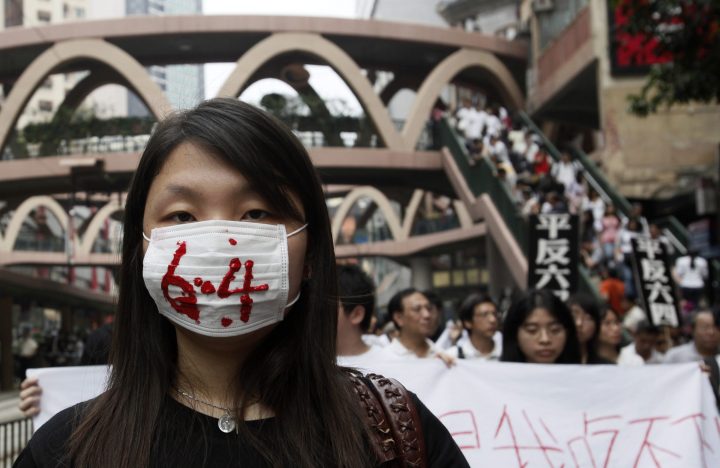 In this file photo, a protester wears a mask painted with the numbers “6.4” at a pro-democracy march in Hong Kong on May 31, 2009.