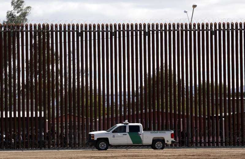FILE - In this April 5, 2019, file photo, a U.S. Customs and Border Protection vehicle sits near the wall as President Donald Trump visits a new section of the border wall with Mexico in El Centro, Calif. A federal judge has denied a request by the U.S. House of Representatives to prevent President Donald Trump from tapping Defense Department money for a border wall with Mexico. 