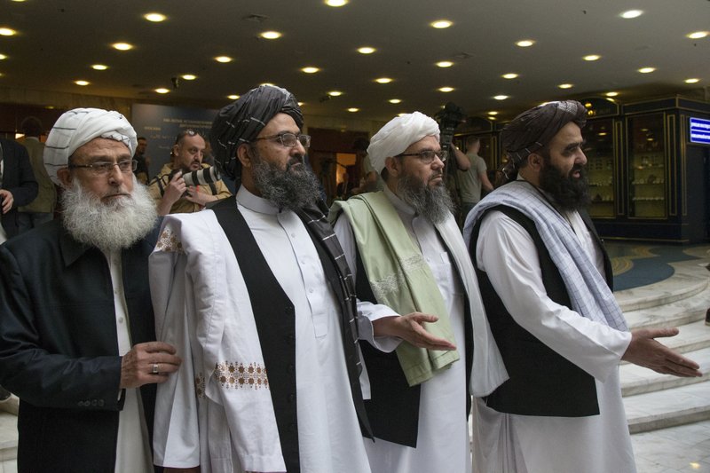 FILE - In this file photo taken on Tuesday, May 28, 2019, Mullah Abdul Ghani Baradar, the Taliban group's top political leader, second from left, arrives with other members of the Taliban delegation for talks in Moscow, Russia.