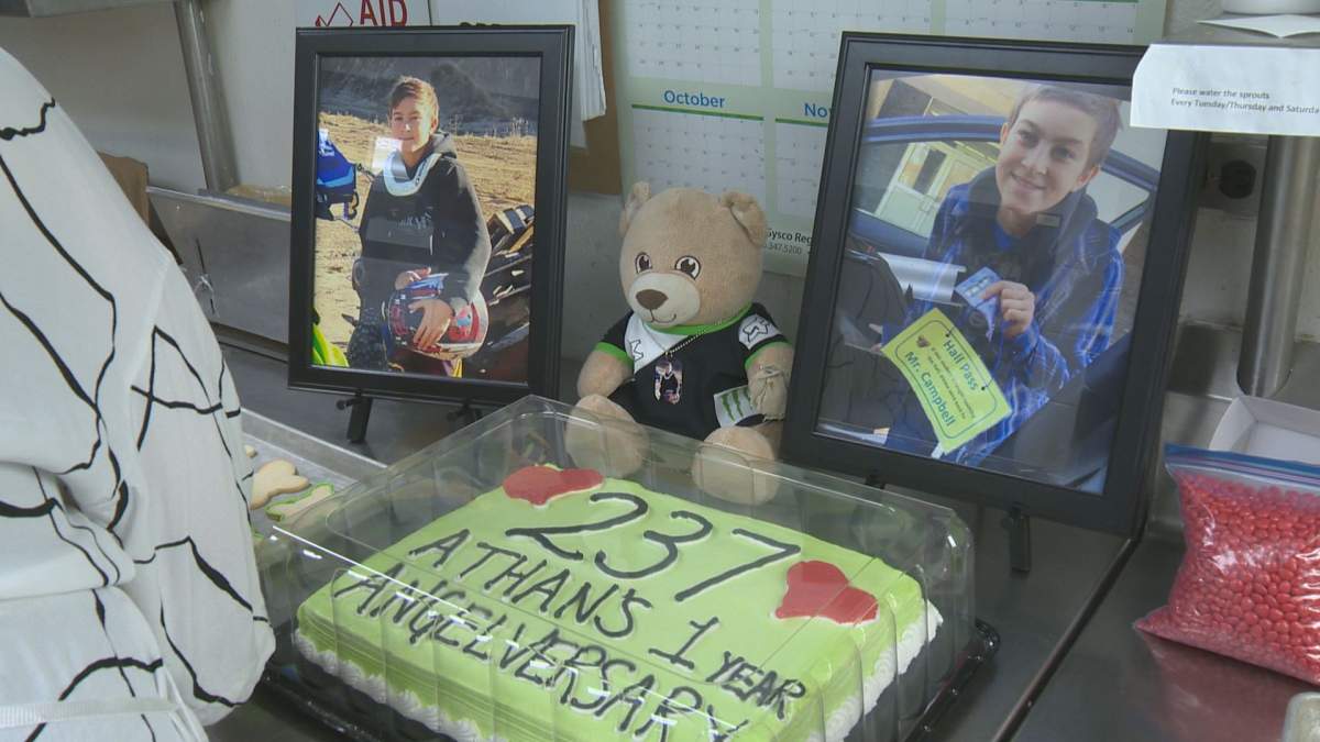 Photos of Athan McEwen accompany a cake that will be given to his welding class at Miller High School.