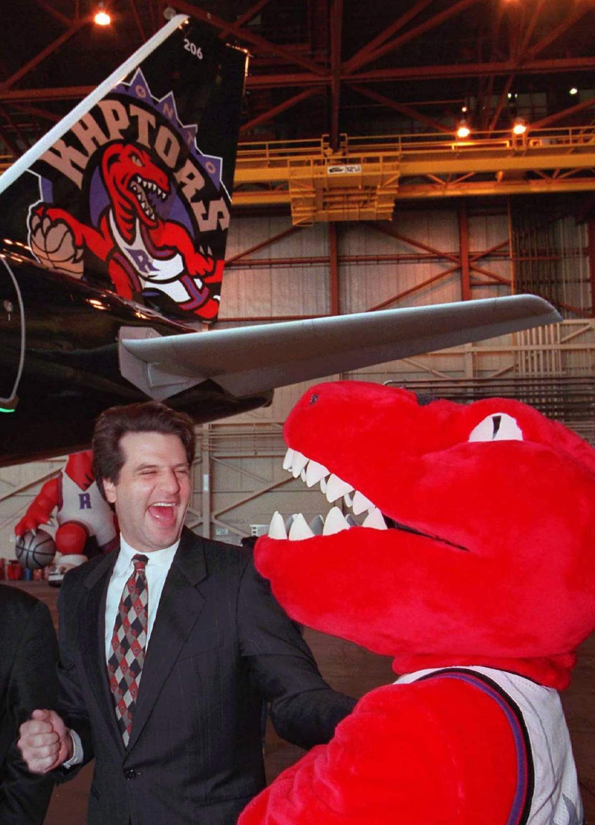 Toronto Raptors president John Bitove Jr. celebrates with the team mascot in front of the tail section of the Raptor’s Air Canada A320 at its unveiling in Toronto on Dec. 4, 1995.