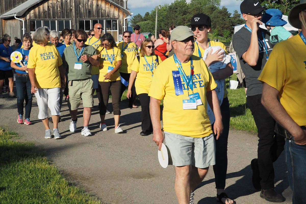 Cancer survivors do a victory lap at a past Relay For Life, held by the Canadian Cancer Society.