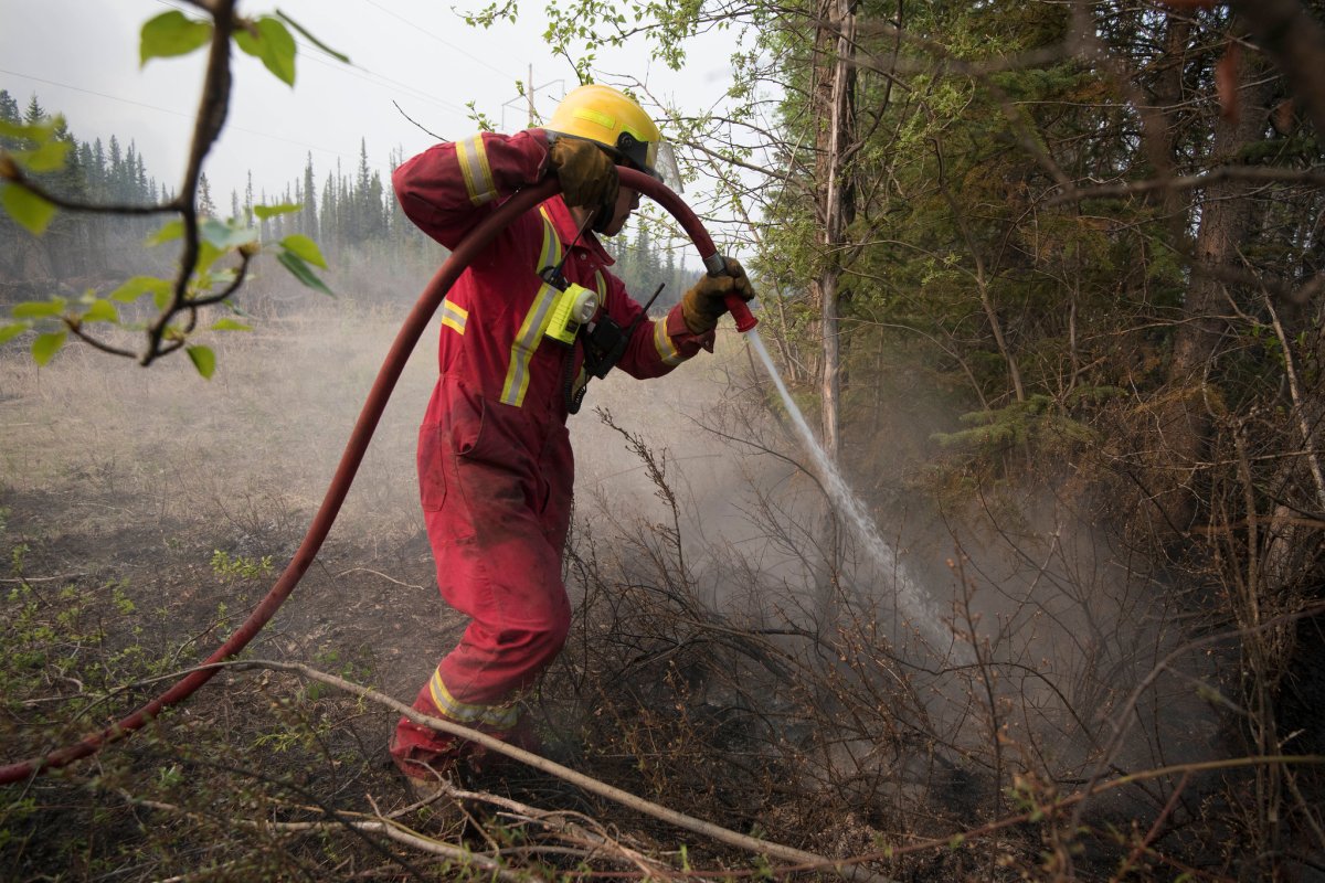 Fire crews work to put out hot spots on the Chuckegg Creek wildfire on May 24, 2019. 
