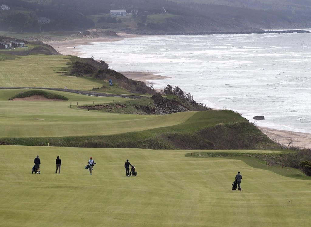 Golfers walk the fairway on the 528 yard, par 5, 18th hole at Cabot Cliffs, the seaside links golf course rated the 19th finest course in the world by Golf Digest, is seen in Inverness, N.S. on Wednesday, June 1, 2016.