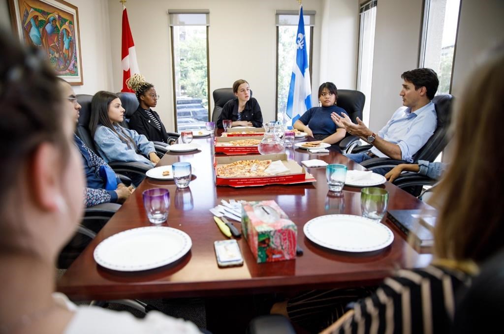 Justin Trudeau speaks with the Papineau Youth Council in Montreal in this photo posted to his Twitter page on Monday, June 24, 2019. The federal Conservatives are attacking Prime Minister Justin Trudeau for hypocrisy over plastic cutlery that was available at a lunch meeting with youth activists in his Montreal riding. Trudeau tweeted a picture of himself having lunch with about half a dozen members of the Papineau Youth Council Monday, including pizzas in cardboard boxes, paper plates, a pitcher of water with glasses, and a handful of plastic forks. THE CANADIAN PRESS/HO, Twitter, @JustinTrudeau.