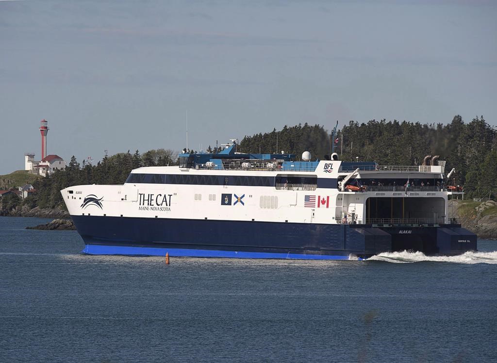 The CAT, a high-speed passenger ferry, passes the Cape Forchu Lighthouse as it departs Yarmouth, N.S. heading to Portland, Maine on its first scheduled trip on Wednesday, June 15, 2016.