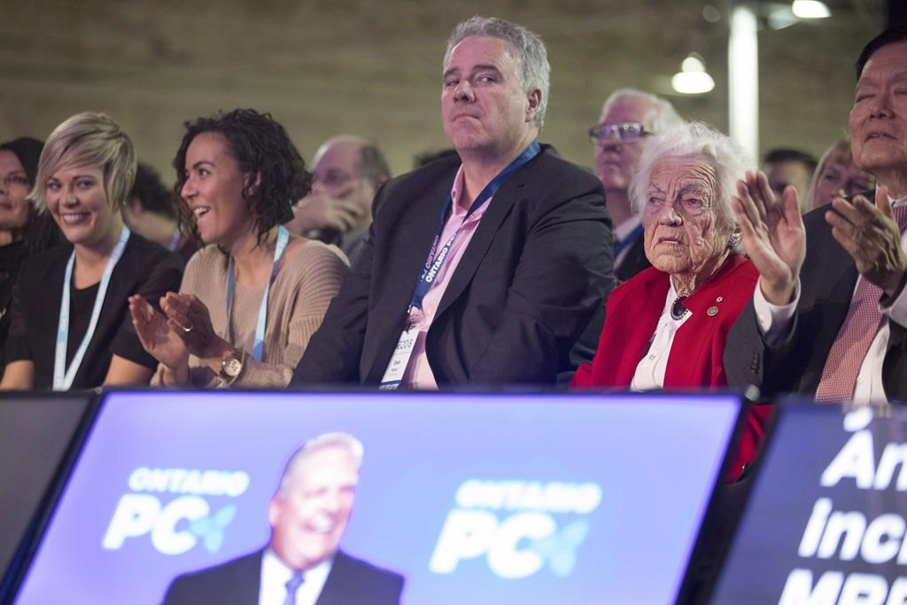 Dean French, centre, chief of staff for Doug Ford, listens to the Ontario Premier speak at the Ontario PC Convention in Toronto, on Friday November 16, 2018.