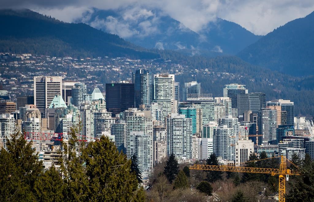 A crane is seen at a condo development under construction as condo and office towers fill the downtown skyline in Vancouver, B.C., on Friday March 30, 2018.
